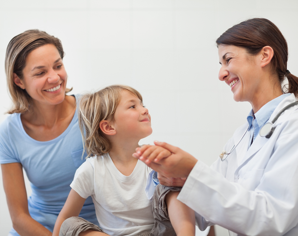 Pediatrician with parent and young boy