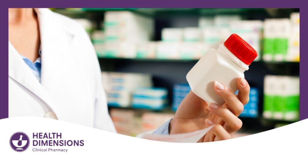 a photo of a pharmacist holding a medication bottle